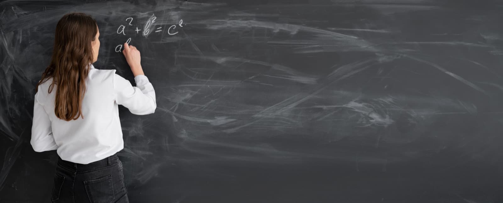 Faculty writing on a chalkboard